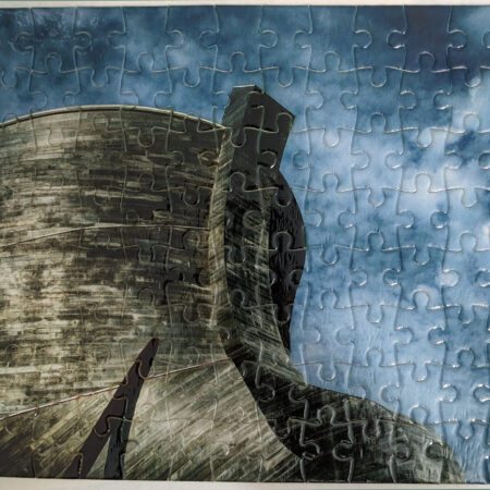 Close-up of a jigsaw puzzle featuring a silhouette against a blue sky.