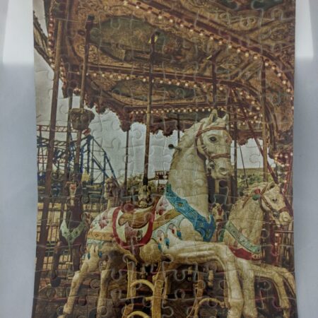 Vintage carousel horses on a decorative merry-go-round.